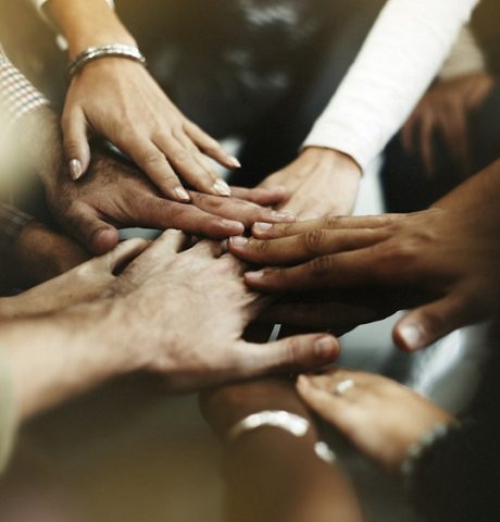 Closeup of diverse people joining their hands